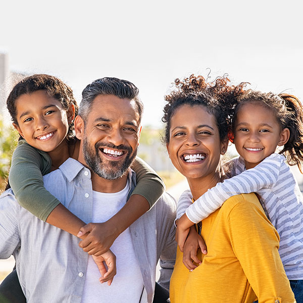Contact Us Family Smiling Outdoors
